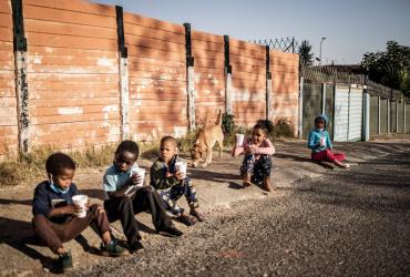 Children in South Africa eat porridge distributed by the non profit organisation and charity group -Hunger has no Religion CREDIT: MARCO LONGARI/AFP